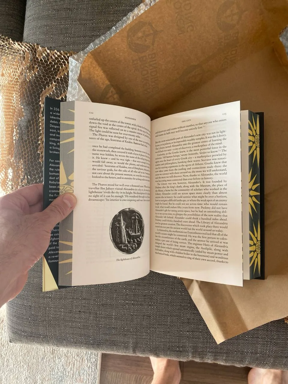 a random page inside the book, showing text and an illustration of the lighthouse of Alexandria